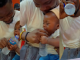 Adorable moment a toddler attempts to imitate his father's drinking method by grabbing the bottle of water (WATCH)