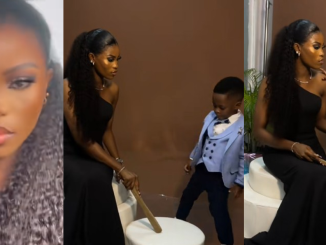 Nigerian mum uses a wooden stick to caution her son during their photo shoot (WATCH)